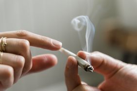 A person passing marijuana to another person.