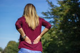 Woman rubbing her lower back