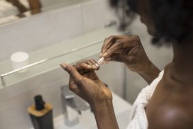a woman removing nail polish
