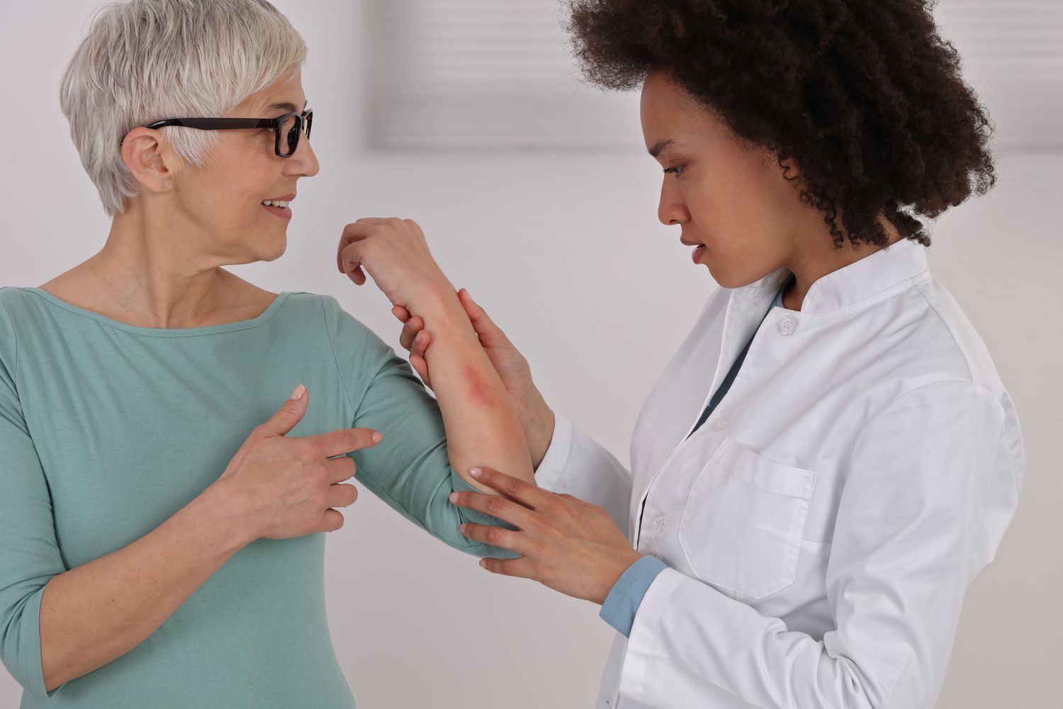 Person showing skin allergy rash to doctor
