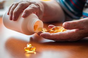 person holding supplement bottle