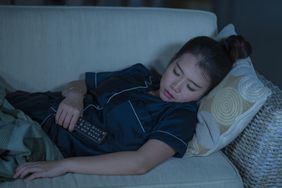 Person asleep in front of the TV. 