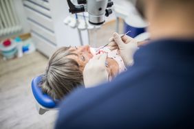 woman being examined by dentist