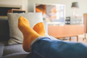 Close-up of person's feet in yellow socks.