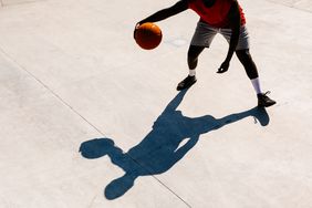 man playing basketball shadow