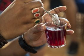 A person adds sugar alcohol to a drink