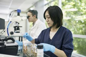 Person testing urine test for ketones in lab