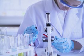 scientist checking for antibodies under a microscope in a research laboratory 