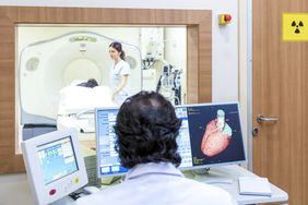 doctor in a medical laboratory completing a heart MRI scan on person with an enlarged heart 
