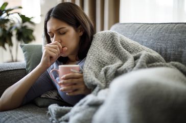 Sick woman coughing