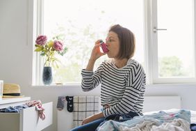 woman using asthma inhaler