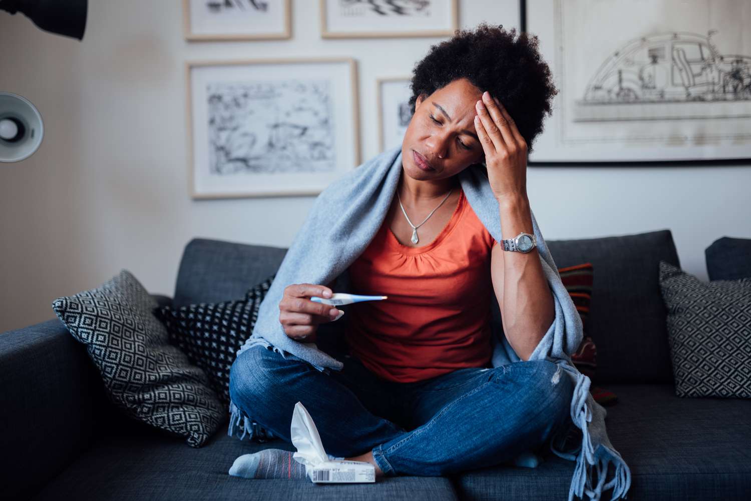 Sick woman sitting on a couch