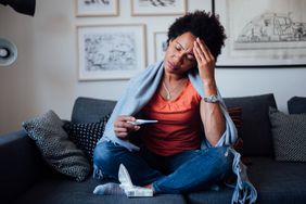 Sick woman sitting on a couch