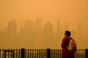 person wears face mask in wildfire smoke in New York City