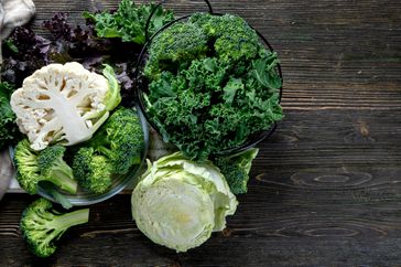 An assortment of cruciferous vegetables on a table. 
