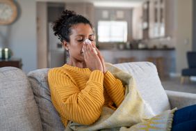 Cold sick person blowing nose