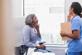 black woman seeing dermatologist to learn what caused hidradenitis suppurativa