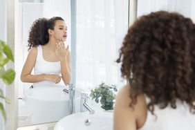 woman looking at herself in the mirror