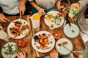 Group of friends eating breakfast or brunch in a restaurant.