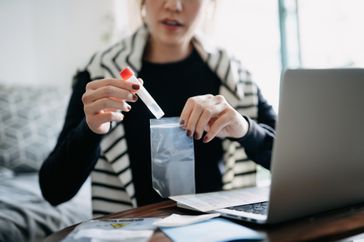 Woman holding a medical test tube