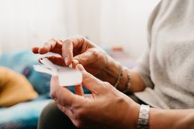 Older woman holding a pill