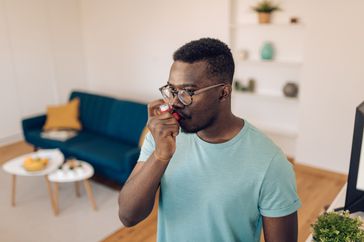 person with eosinophilic asthma using inhaler