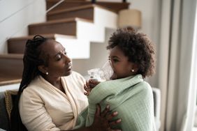 mother helping daughter with asthma