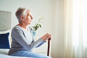 woman sitting along looking out window