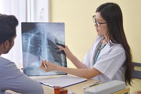Doctor showing x-ray of hiatal hernia to patient