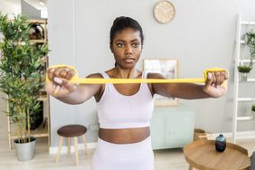 Person holds a resistance band during an at-home workout.