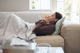 Sick woman lying on couch