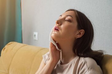 person going through a thyroid storm experiencing symptoms like fever and sweating