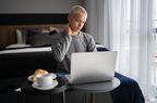 Person experiencing neck pain while using computer