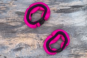 pink and black wrist weights on gray background