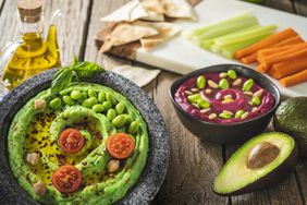 High-protein, high-fiber snacks: Edamame chickpea hummus; beet dip topped with edamame and nuts; celery and carrot sticks; whole-wheat tortillas; avocado; olive oil bottle