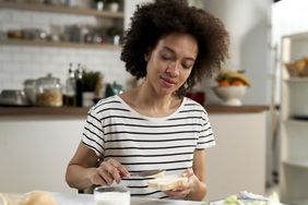 Person makes a sandwich with bread.