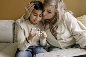 mother helping son with autism with homework