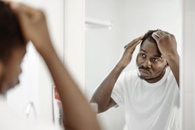 a person looking at their scalp