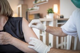 older woman receives covid vaccine