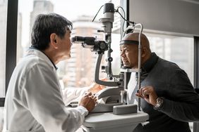 ophthalmologist examining patient's eyes