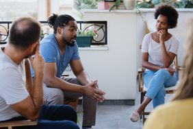 People supporting one another on group therapy session.