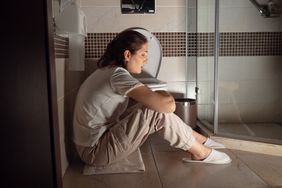 How long does food poisoning last - Person sitting near toilet