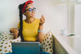 Person eating almonds while they work on their computer.