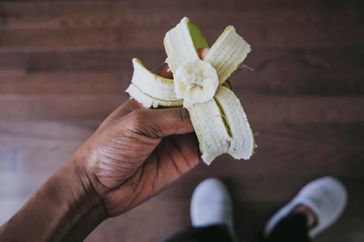 Bird's eye view of a banana peeled and bitten into.