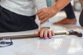 Senior woman falling down at home because she stumbled.
