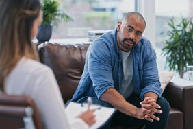 Person working through defense mechanisms in therapy