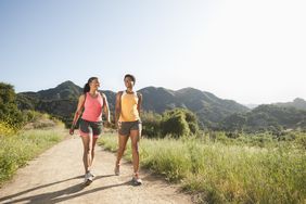 Two women walking on a trail.