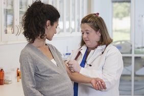 Fetal alcohol syndrome - Pregnant person having blood test in doctor's office