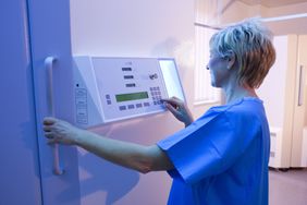 Dermatologist setting up an ultraviolet B phototherapy booth.