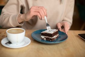 eating sweet treat with coffee